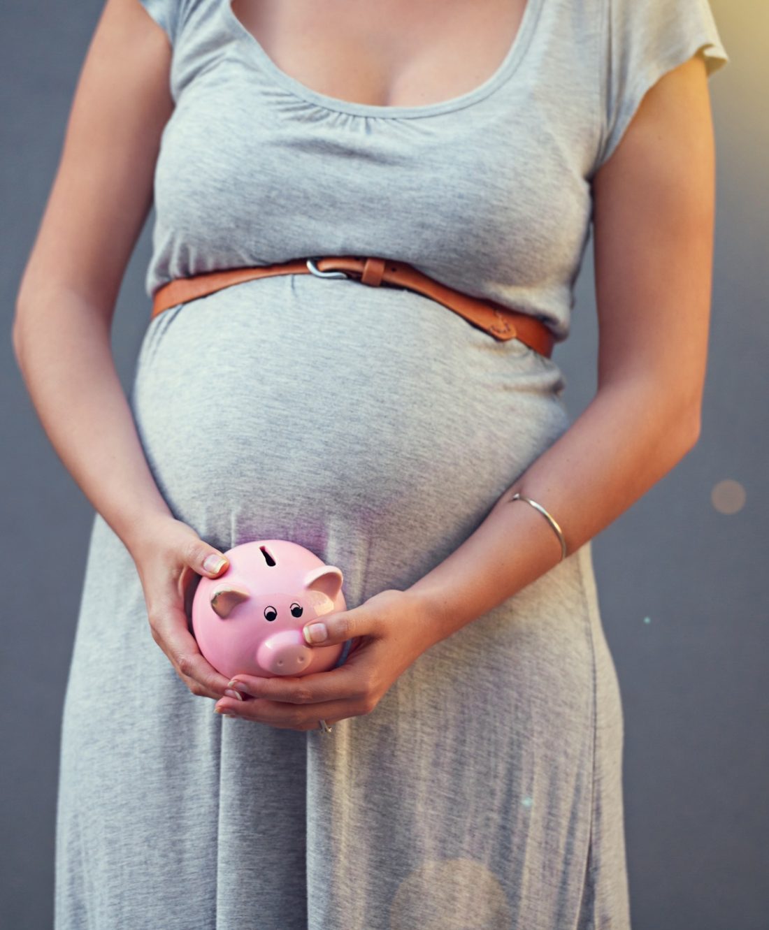 Cropped shot of a pregnant woman holding a piggybank against a gray backgroundhttp://195.154.178.81/DATA/i_collage/pi/shoots/805488.jpg